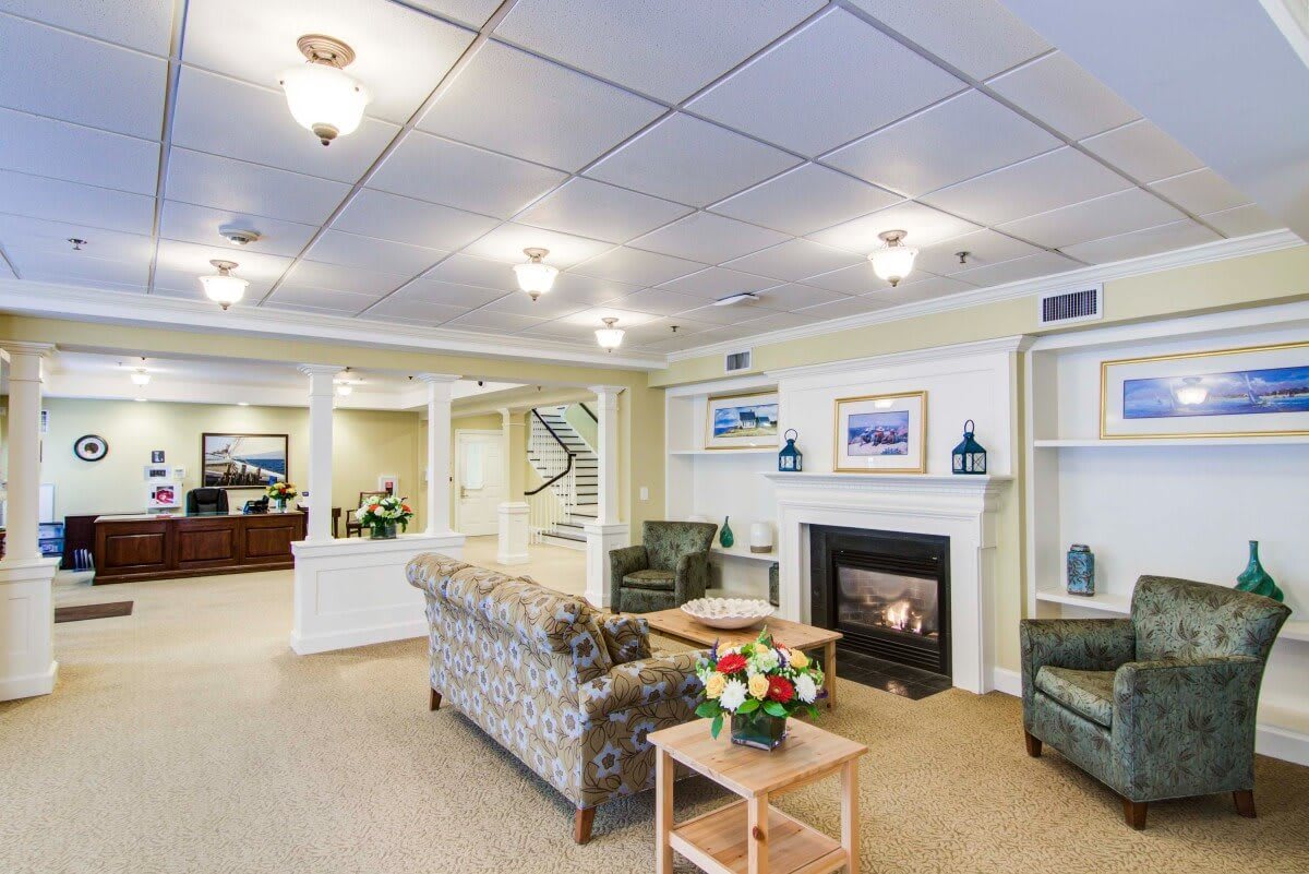 A cozy living room with a fireplace, comfortable sofas, and elegant decor.