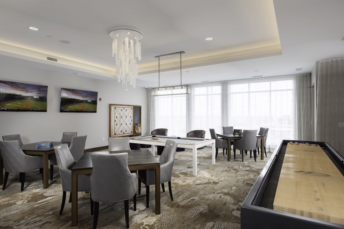 A modern dining room with elegant furniture and decorative lighting.