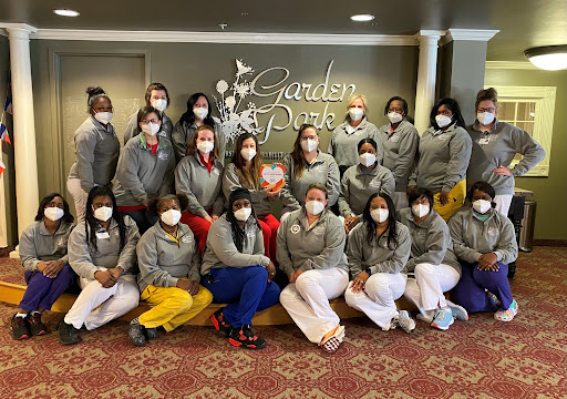Staff members gathered for a group photo at Garden Park, showcasing their teamwork and dedication while following health protocols.