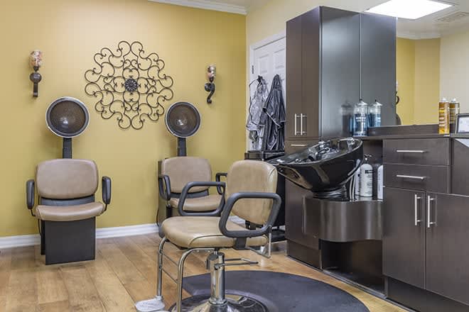 A well-organized hair salon with styling chairs and a wash station.
