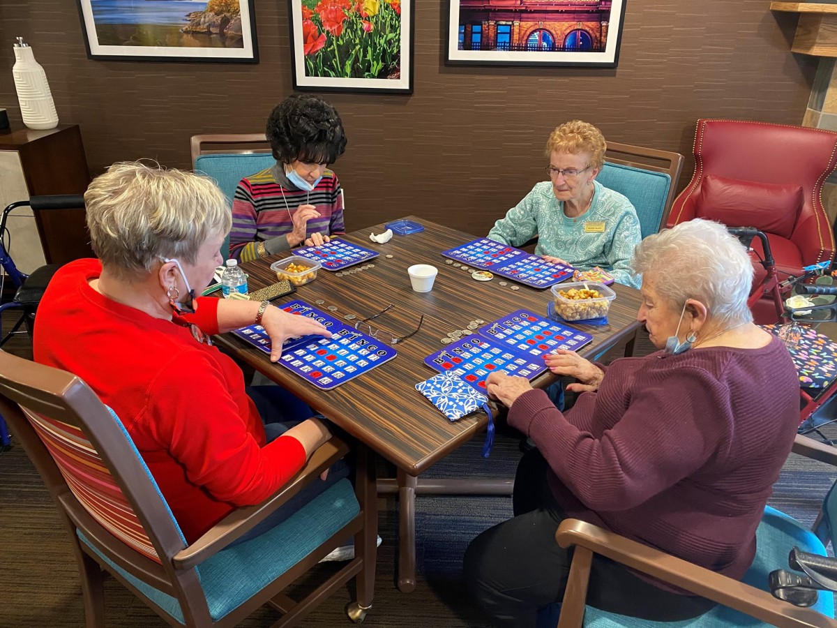 A group of people playing bingo together at a table.