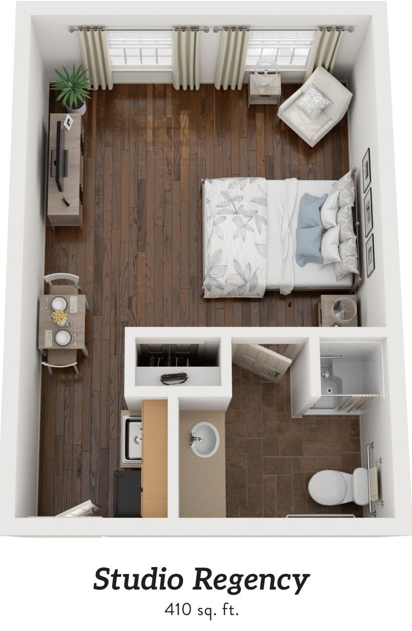 A top-down view of a compact studio apartment layout featuring a bed, seating area, kitchen space, and bathroom.