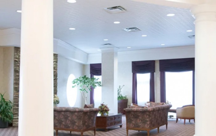 A well-lit lobby area with comfortable seating and decorative plants.