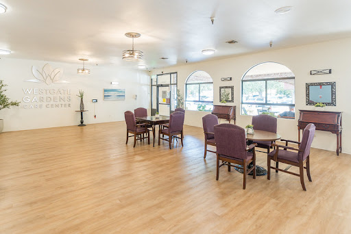 A spacious and bright dining area with purple chairs and tables, featuring large windows.