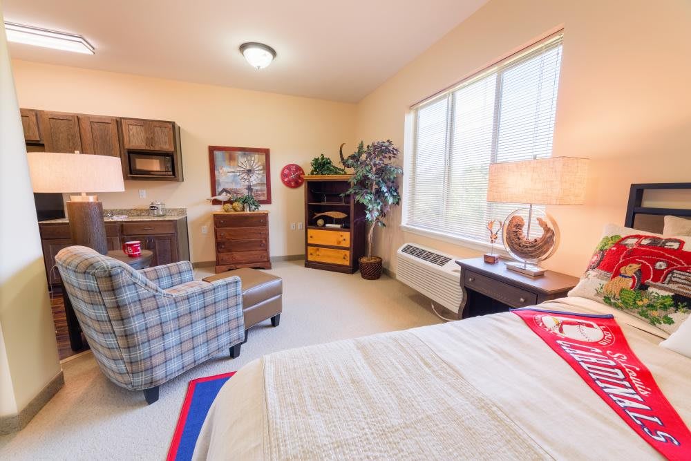 A cozy bedroom with stylish furniture and natural light streaming through the window.
