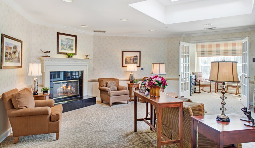 A cozy living room with a fireplace and elegant furniture.