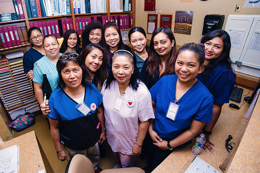 A cheerful group of healthcare professionals posing together in the office.