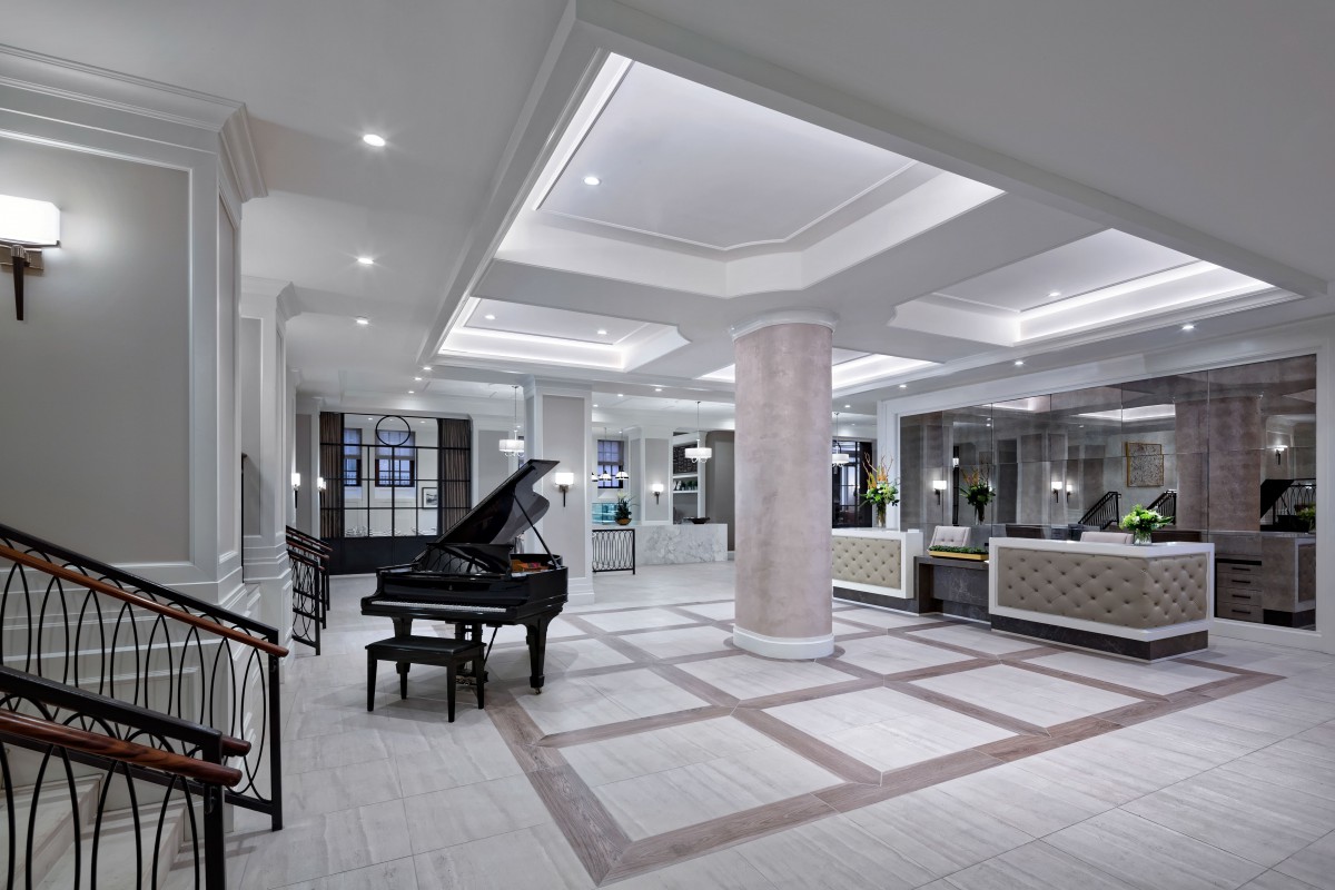 A modern luxury lobby featuring a grand piano and elegant interior design.