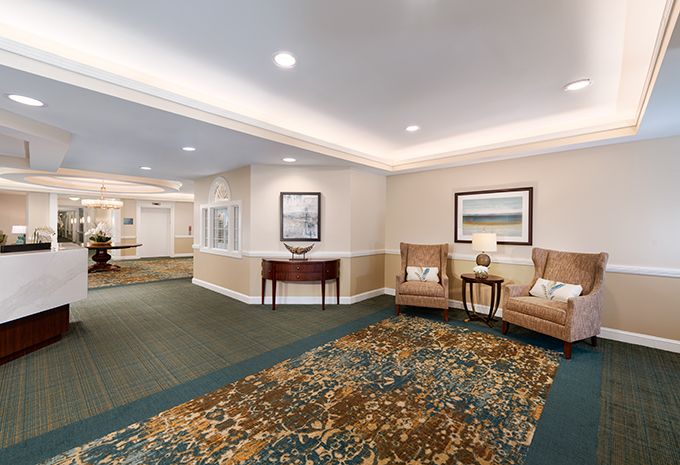 A well-decorated lobby area with chairs and a carpeted floor.