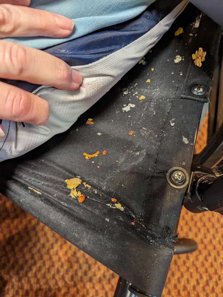 Close-up of a chair showing peeling paint and signs of wear.
