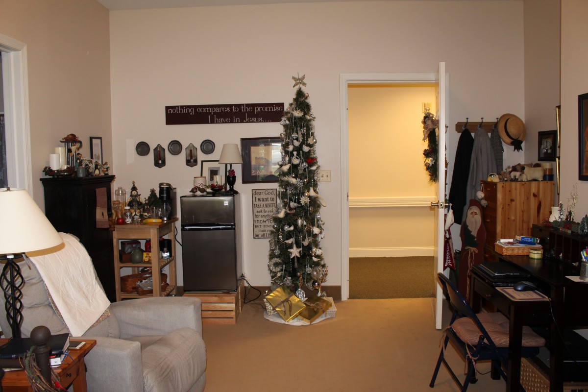 A cozy living room with a Christmas tree and festive decorations.