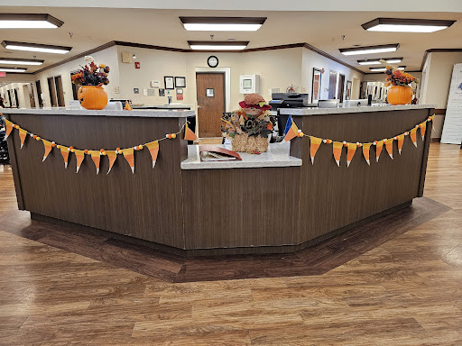A cozy reception area decorated for autumn with pumpkins and bunting.