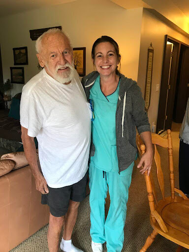 A joyful moment between a caregiver and an elderly man.