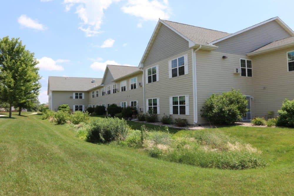 A suburban residential building with a landscaped yard.