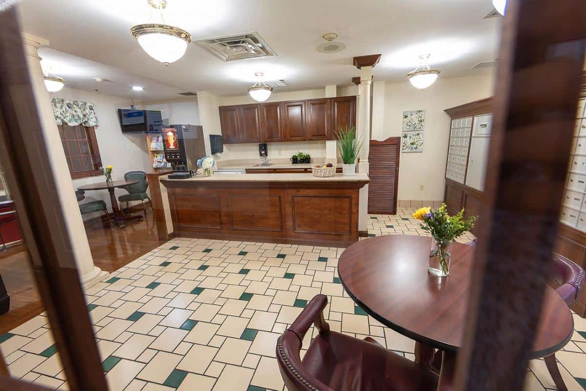 A cozy kitchen and dining area with wood cabinets and a tile floor.