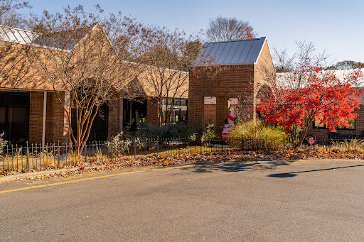 A charming view of brick buildings surrounded by autumn foliage.
