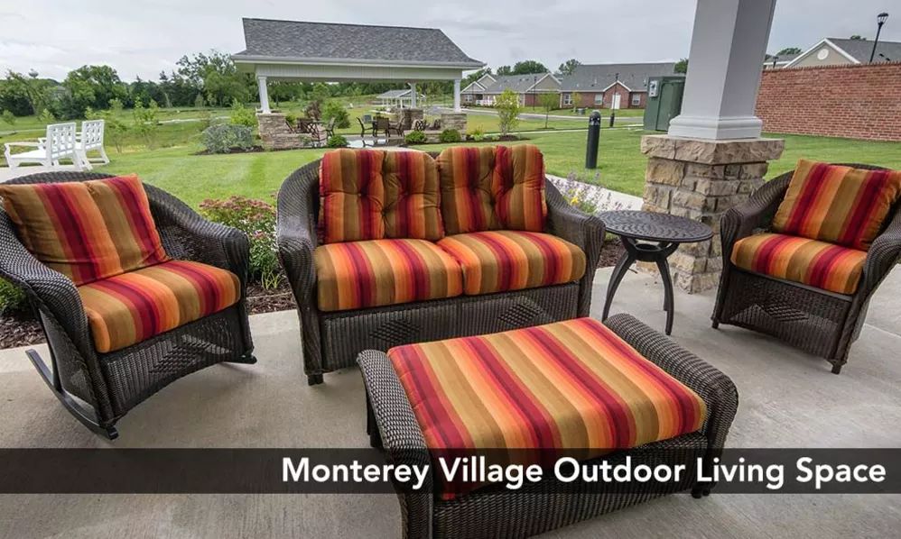 Outdoor seating area with striped cushions at Monterey Village.