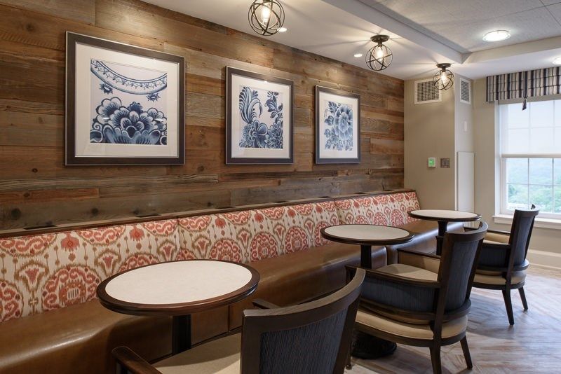 Cozy cafe interior with wooden paneling and artistic decor.