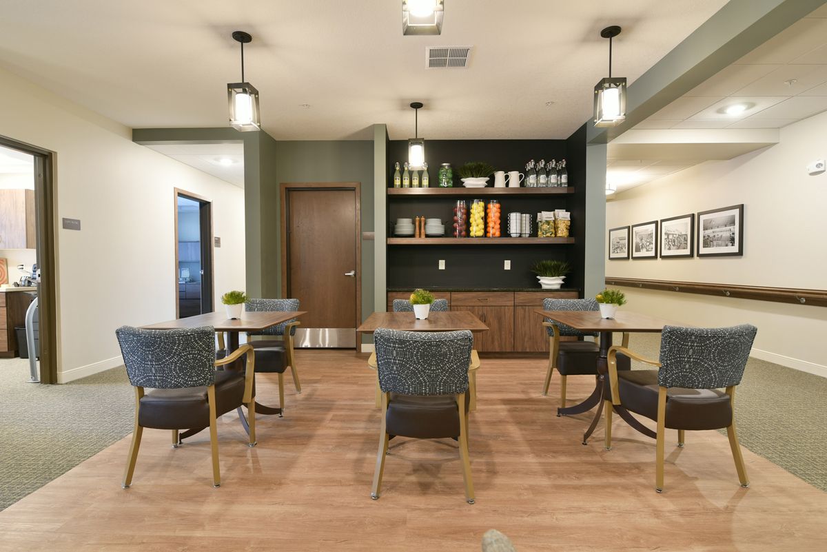 A modern dining area with stylish seating and shelving.
