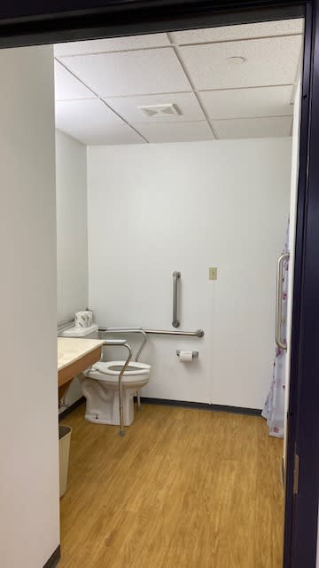 Accessible bathroom with a toilet and grab bar.