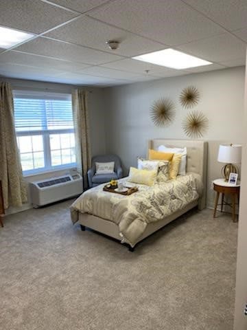 A cozy bedroom with a single bed, soft lighting, and decorative elements.