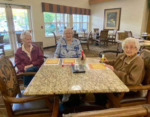 Three friends enjoying a meal together in a cozy dining area.