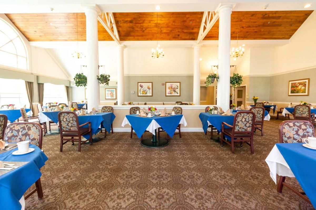 An elegant dining area with blue tablecloths and stylish decor.