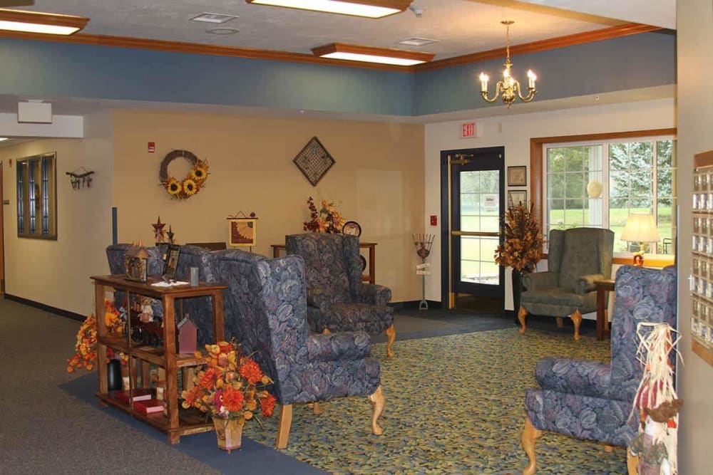A cozy waiting room with blue upholstered chairs and decorative elements.