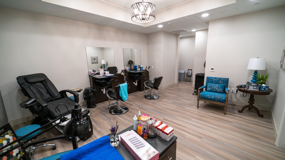 A modern hair salon with styling chairs and mirrors.