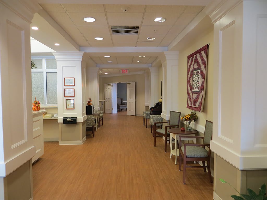A bright and welcoming hallway with seating areas and decorative elements.