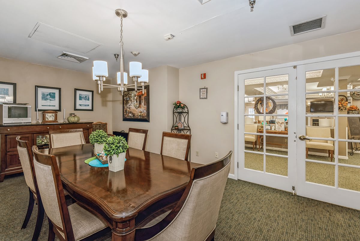 A well-appointed dining room with a large wooden table, elegant chairs, and tasteful decor.