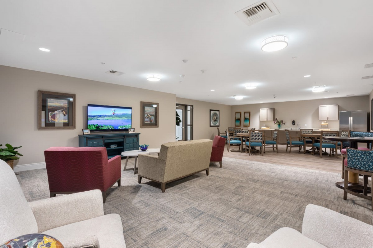 A spacious and modern living room with comfortable seating and a television.