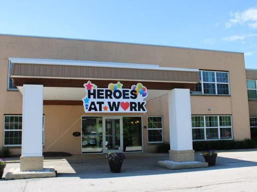 A welcoming building proudly displaying a 'Heroes at Work' banner, symbolizing community support.
