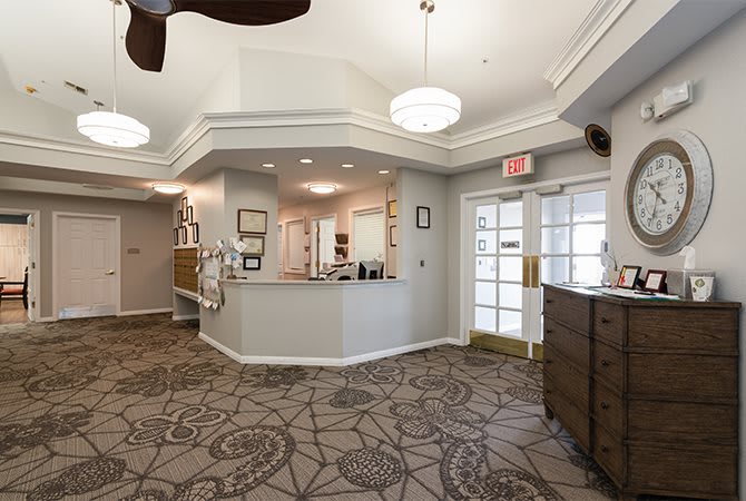 A welcoming reception area with a desk and carpeted floor.