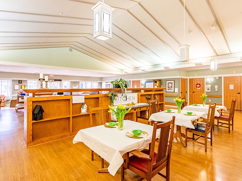 A cozy dining area with neatly set tables and warm, inviting decor.