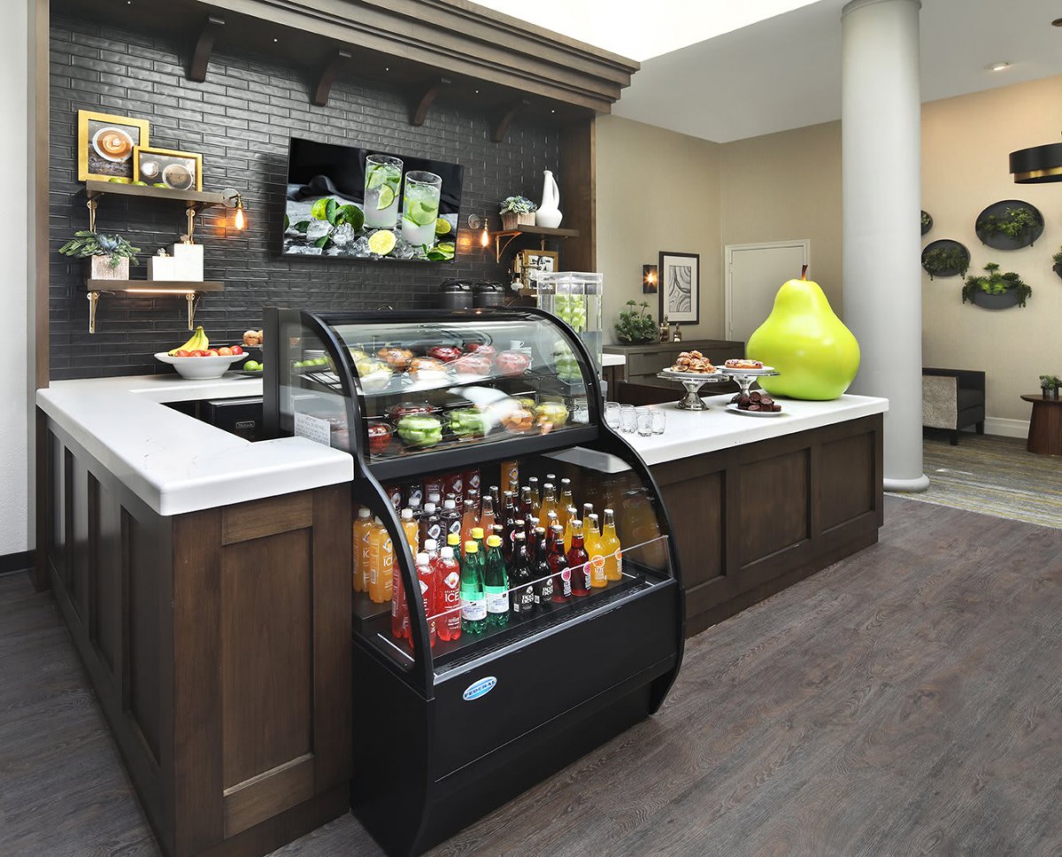 A cozy cafe setup featuring a variety of beverages and snacks on display.
