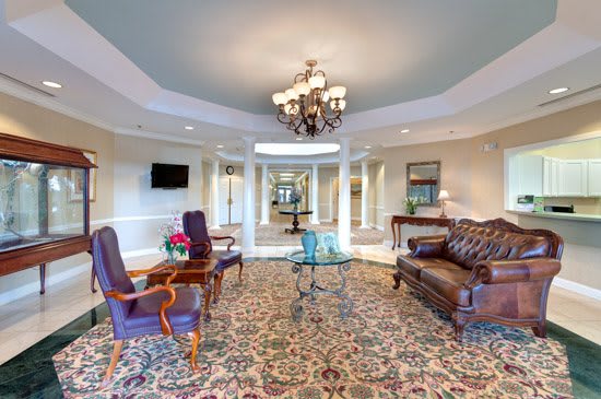 A luxurious lobby with elegant furnishings and a grand chandelier.