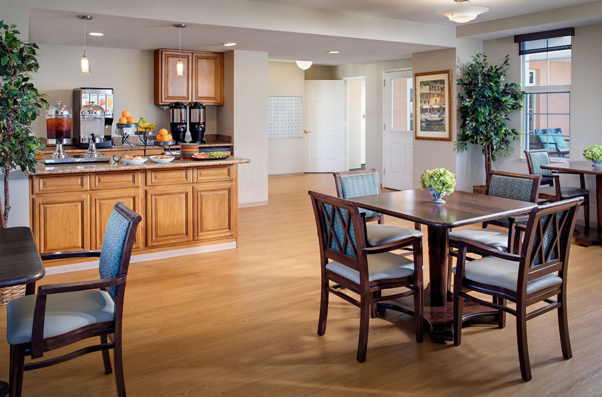 A cozy kitchen and dining area with wooden flooring and elegant furniture.