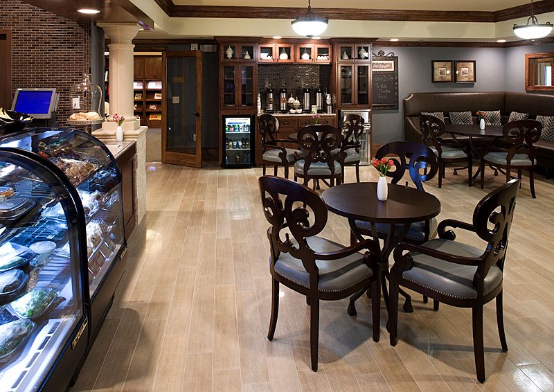 An elegant cafe interior with stylish furniture and warm lighting.