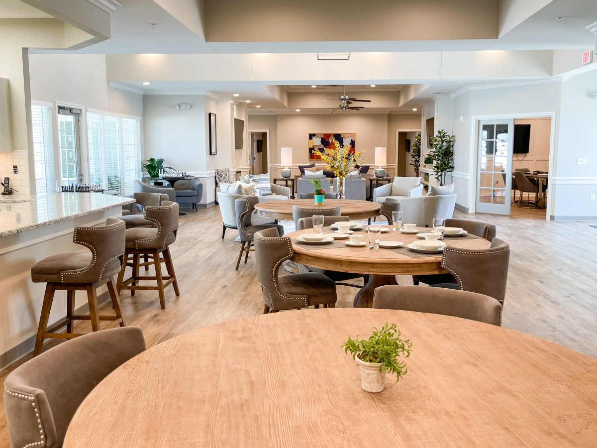 A modern dining room with neatly arranged tables and chairs.