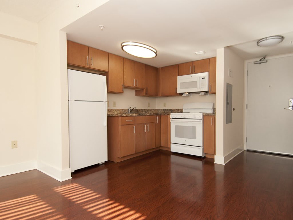 Modern kitchen with wooden cabinets and appliances.