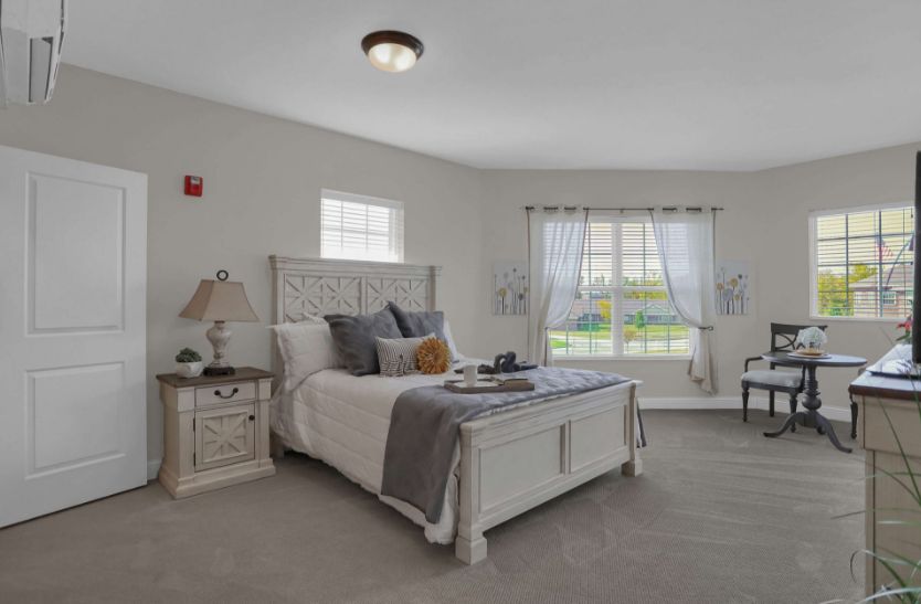 A cozy, well-decorated bedroom with a large bed and ample natural light.