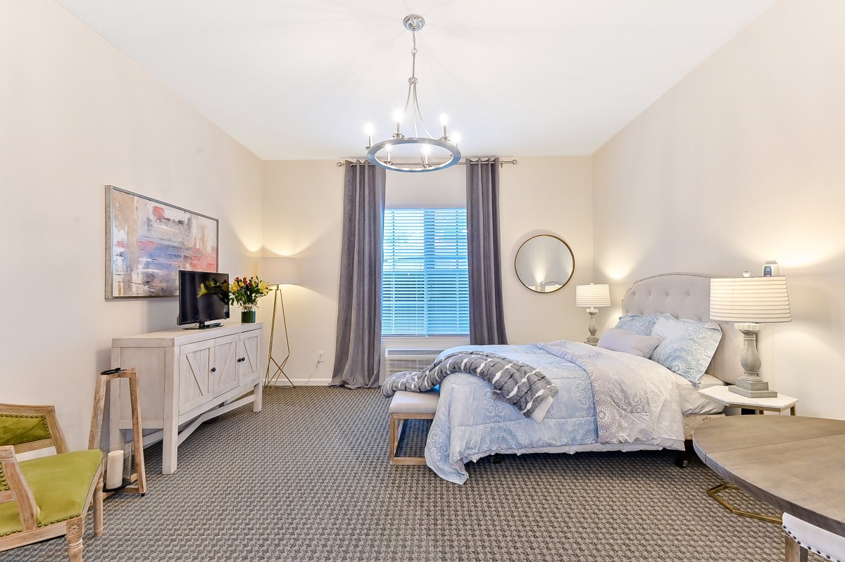 A modern and cozy bedroom with elegant decor and soft lighting.