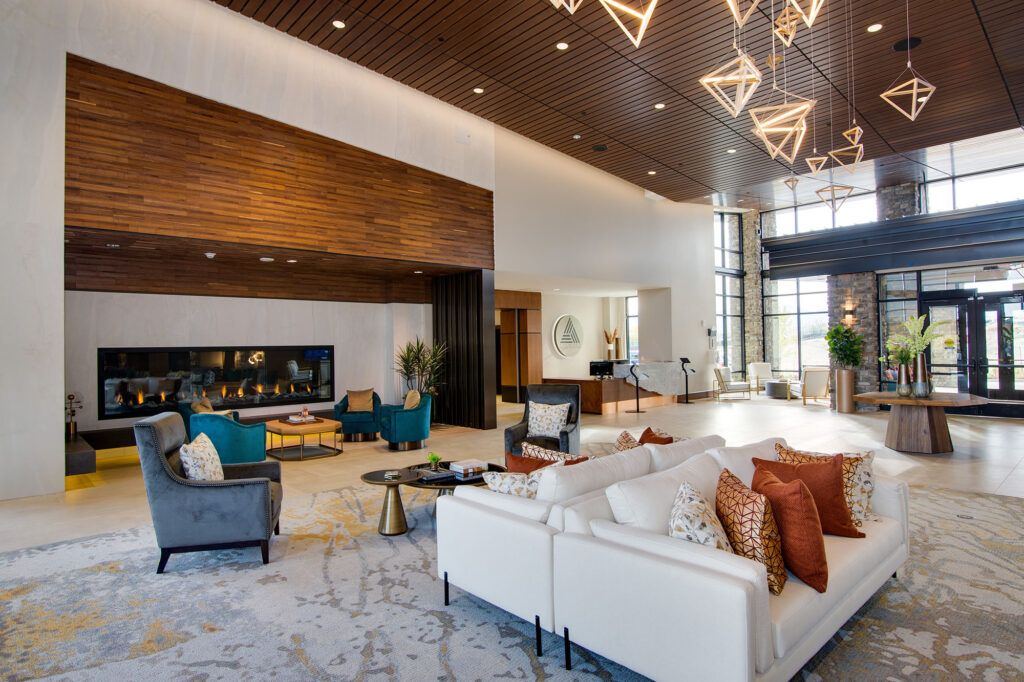 A modern and luxurious hotel lobby with stylish furniture and striking lighting fixtures.
