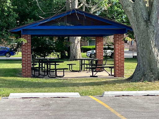 A sheltered picnic area with tables, perfect for outdoor gatherings.