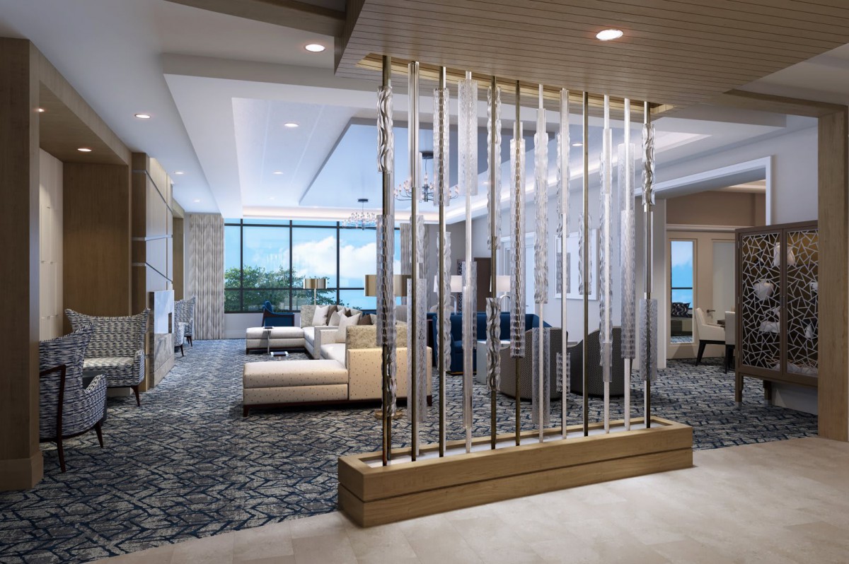 A modern and spacious lobby with elegant furniture and a glass partition.