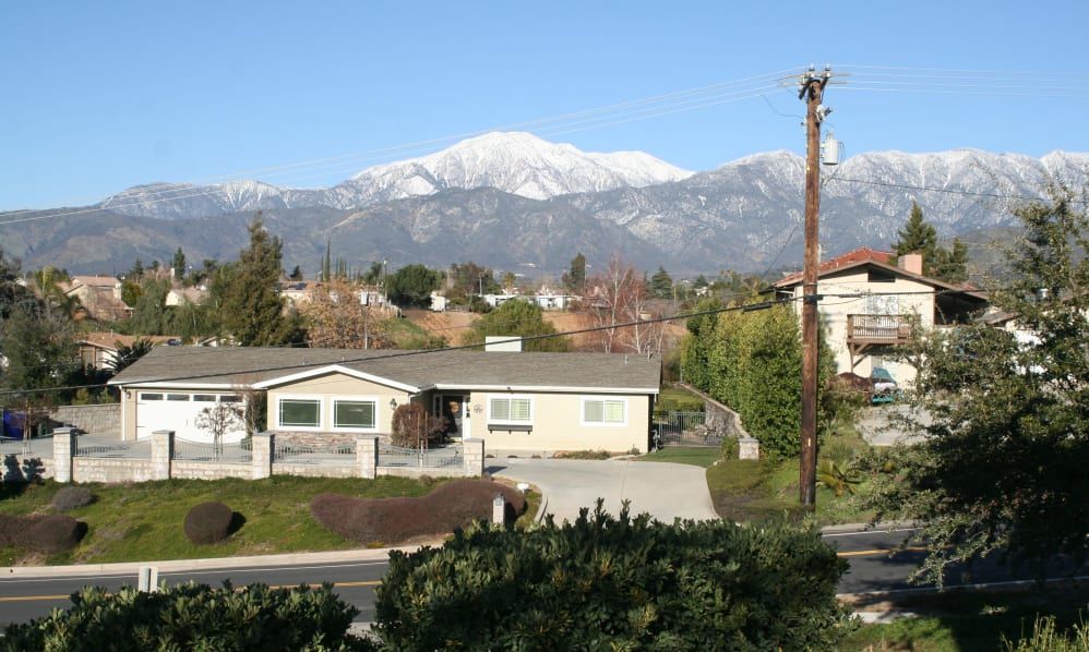 A suburban house with a mountain view in the background.