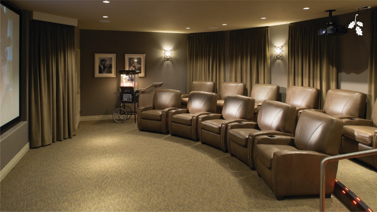 A luxurious home theater room with comfortable reclining chairs and soft lighting.
