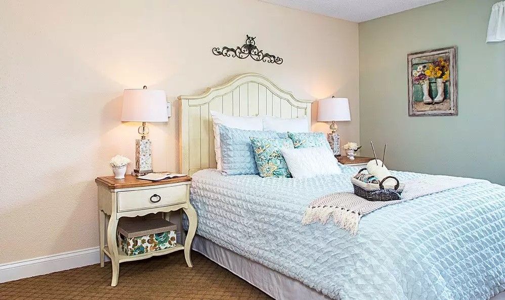 Cozy bedroom with classic decor and soft lighting.