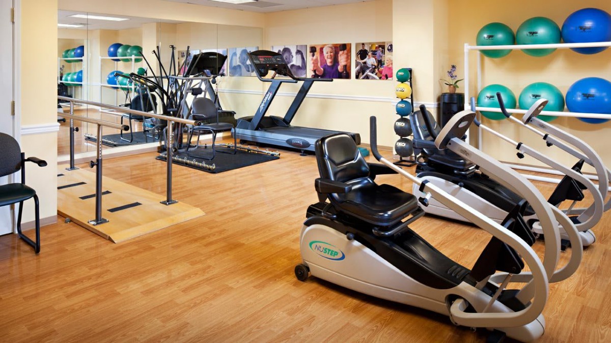 A well-equipped gym with treadmills and stationary bikes.